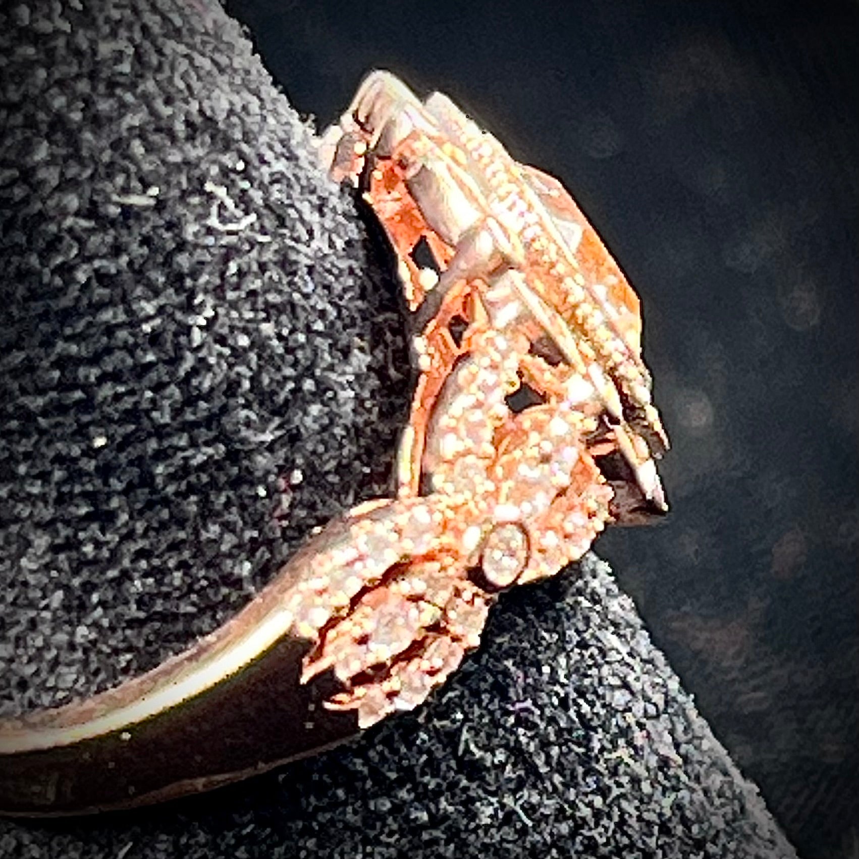 A rose gold plated ring set with a cushion cut morganite stone surrounded by cubic zirconia halos.