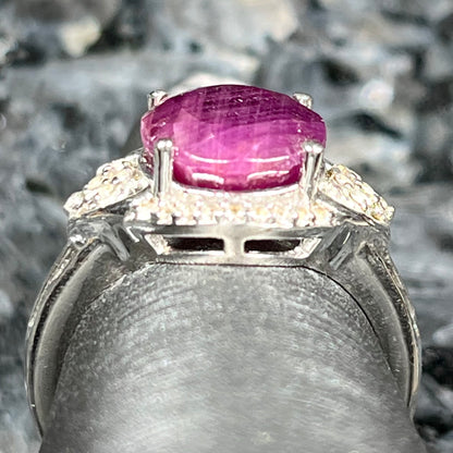 An oval cut natural ruby set in a sterling silver ring.
