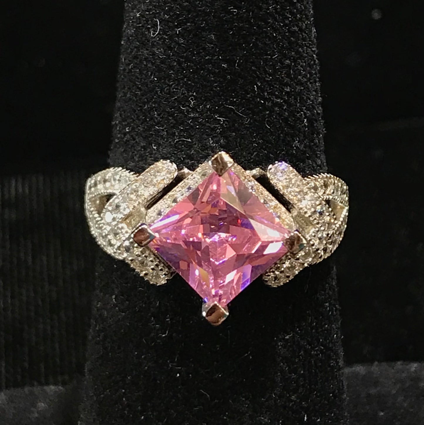 Pink cubic zirconia ring set in sterling silver with white cubic zirconia melee.