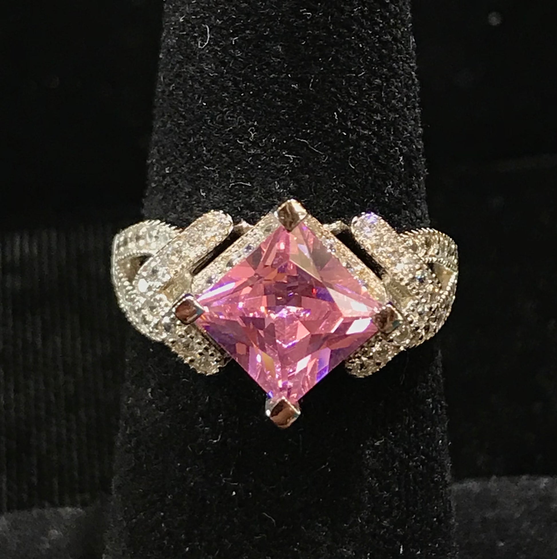 Pink cubic zirconia ring set in sterling silver with white cubic zirconia melee.