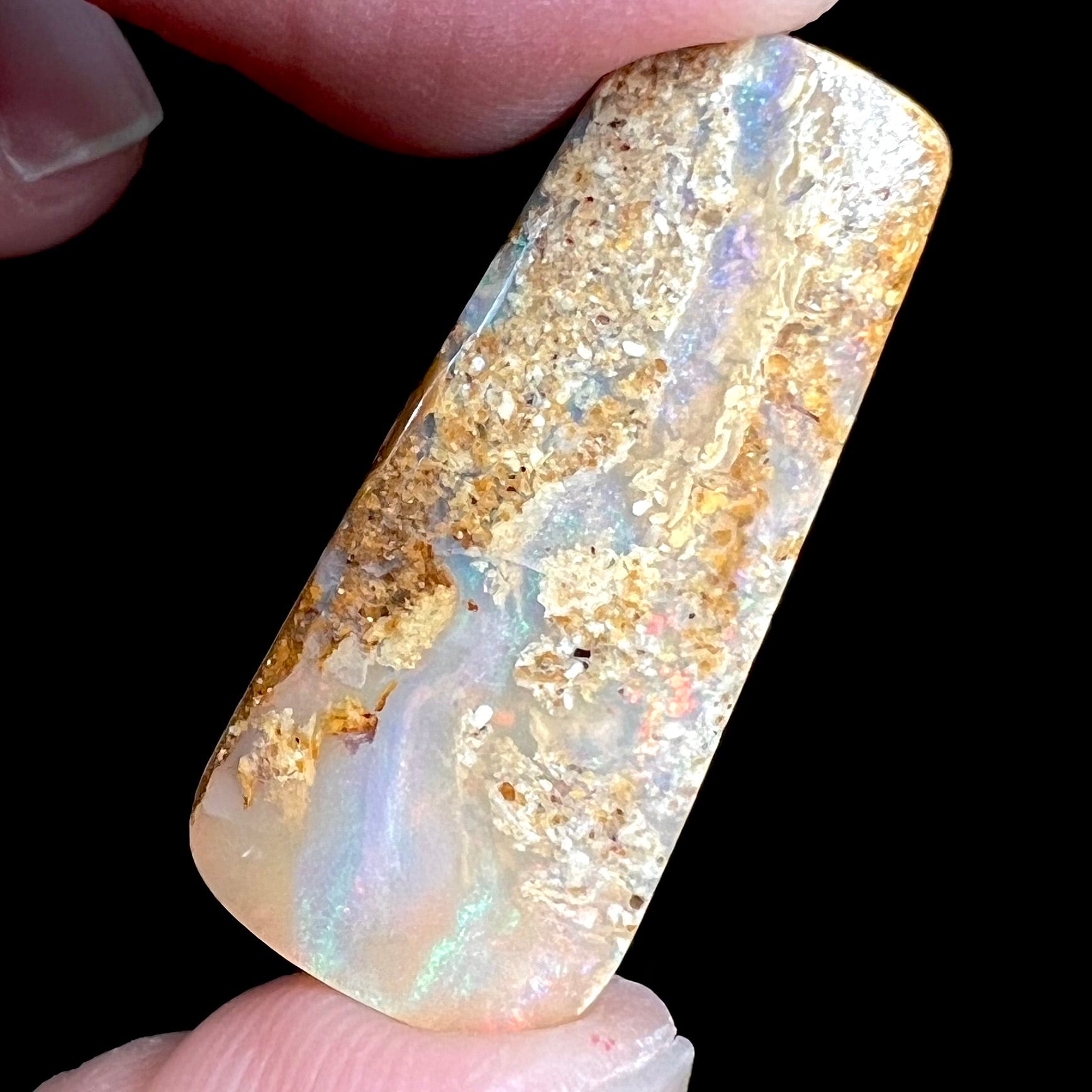 A polished, drilled pipe boulder opal bead.
