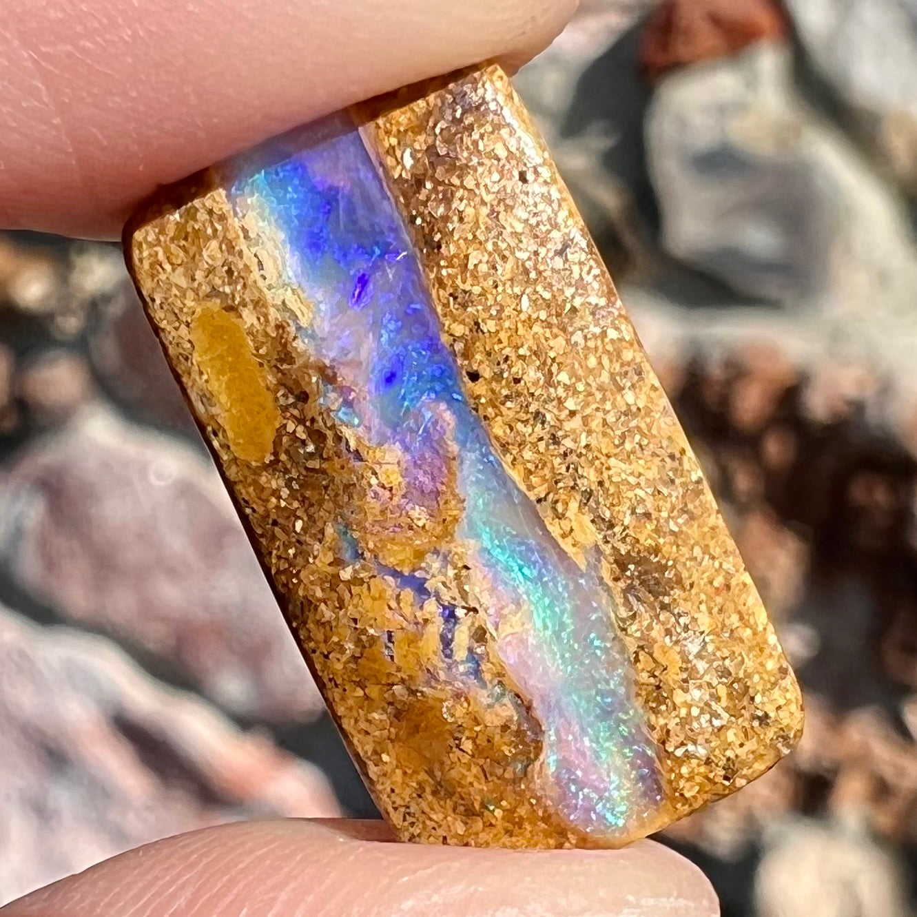 A polished, drilled pipe boulder opal bead.
