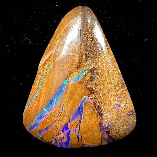 A polished, drilled pipe boulder opal bead.