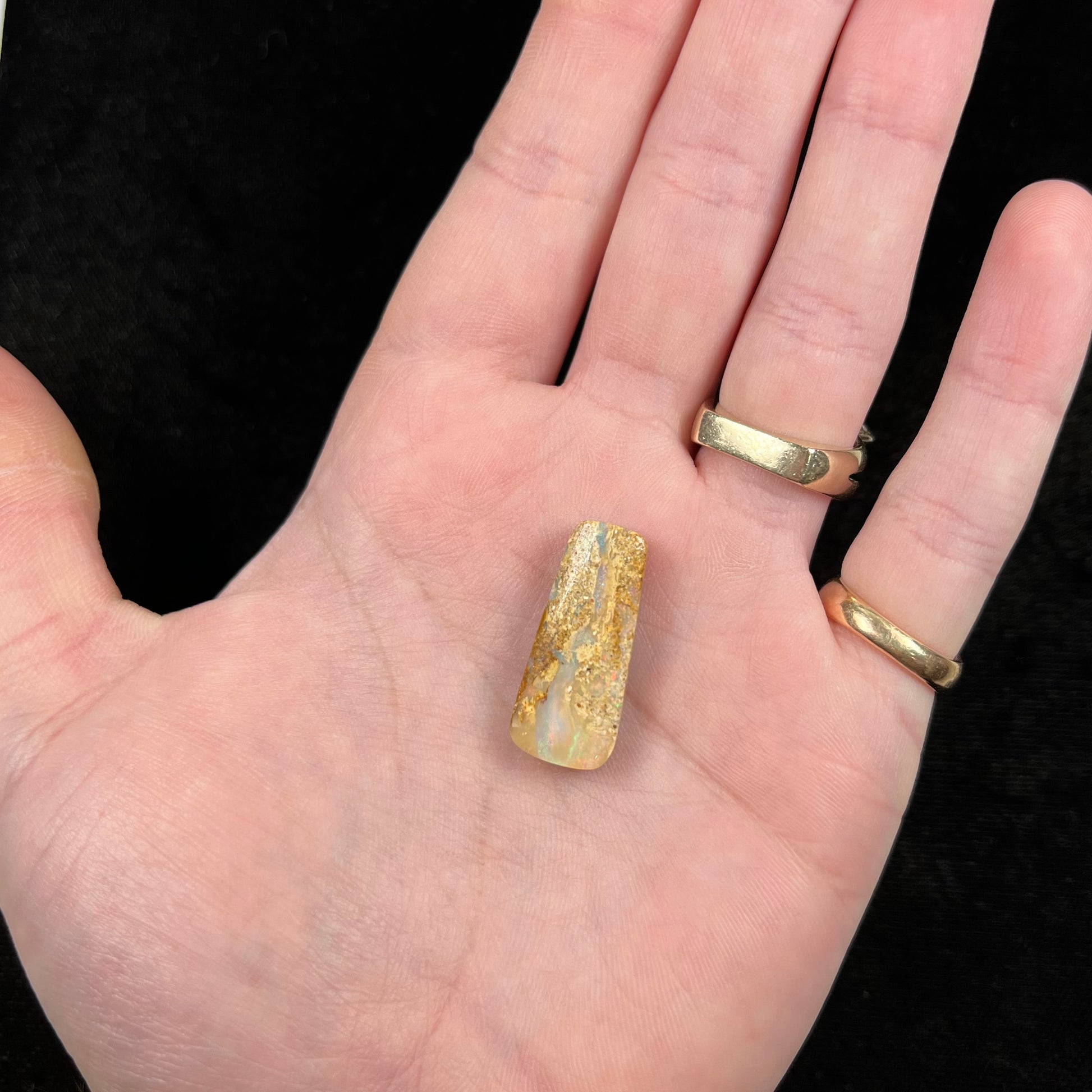 A polished, drilled pipe boulder opal bead.