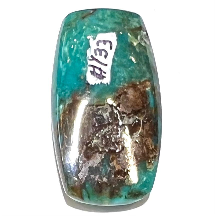 A loose turquoise stone from Royston Mining District, Nevada.  The stone is blue green with brown matrix veining.