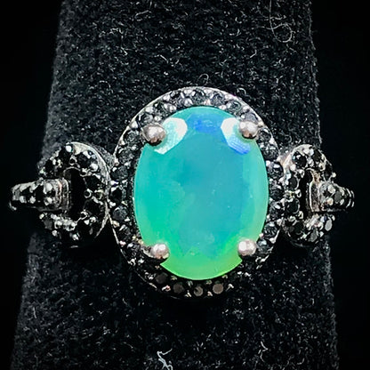 Dyed Ethiopian opal and black spinel prong set into a sterling silver ring.