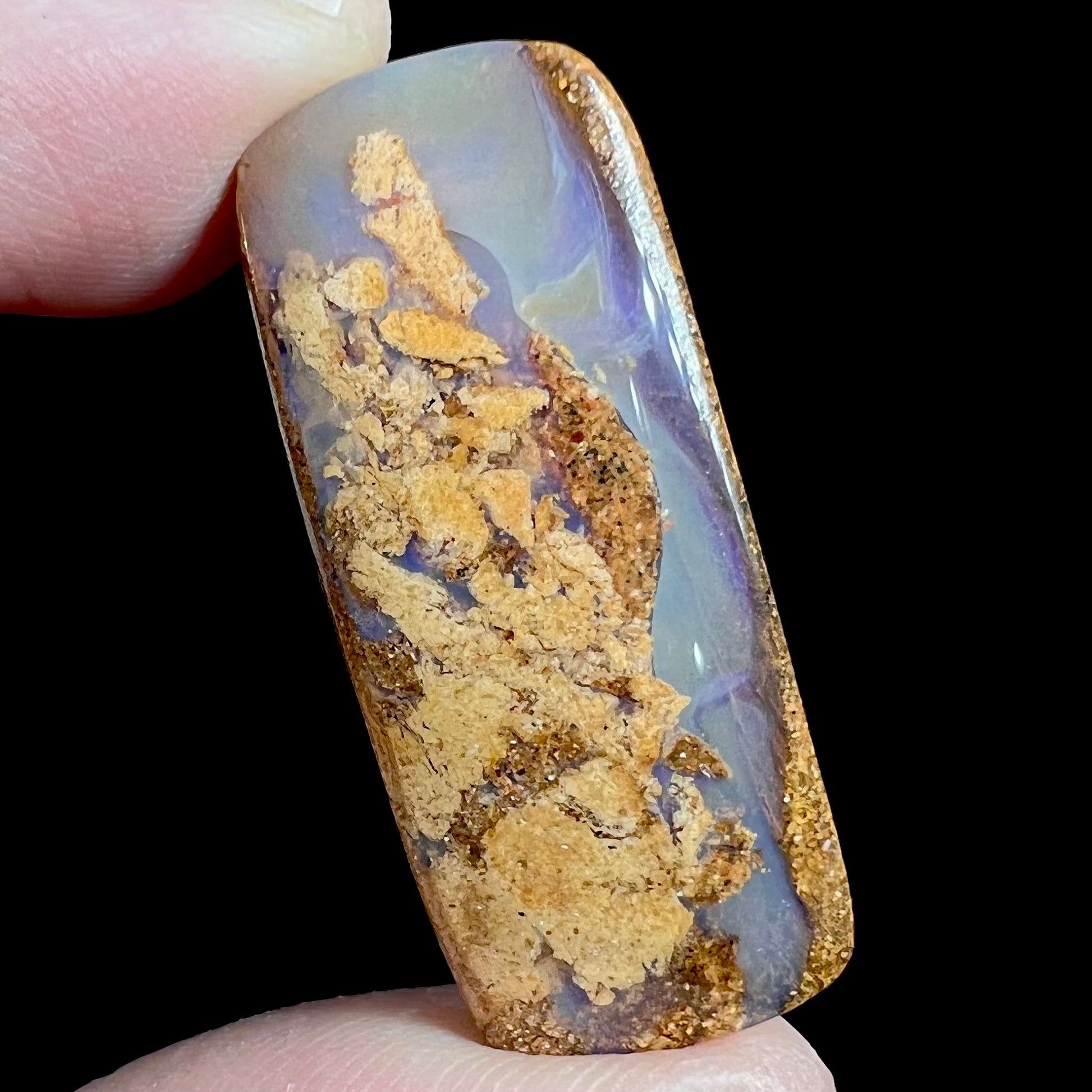 A polished, drilled pipe boulder opal bead.