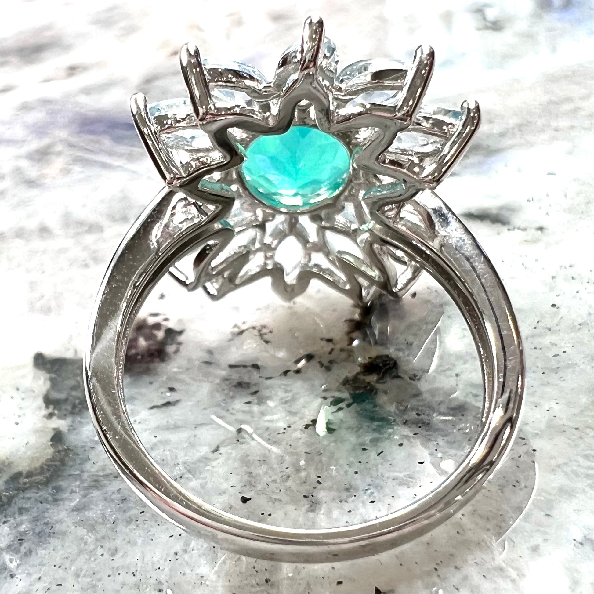 A faceted oval cut blue Ethiopian fire opal set in a sterling silver ring with marquise cut blue topaz stones.
