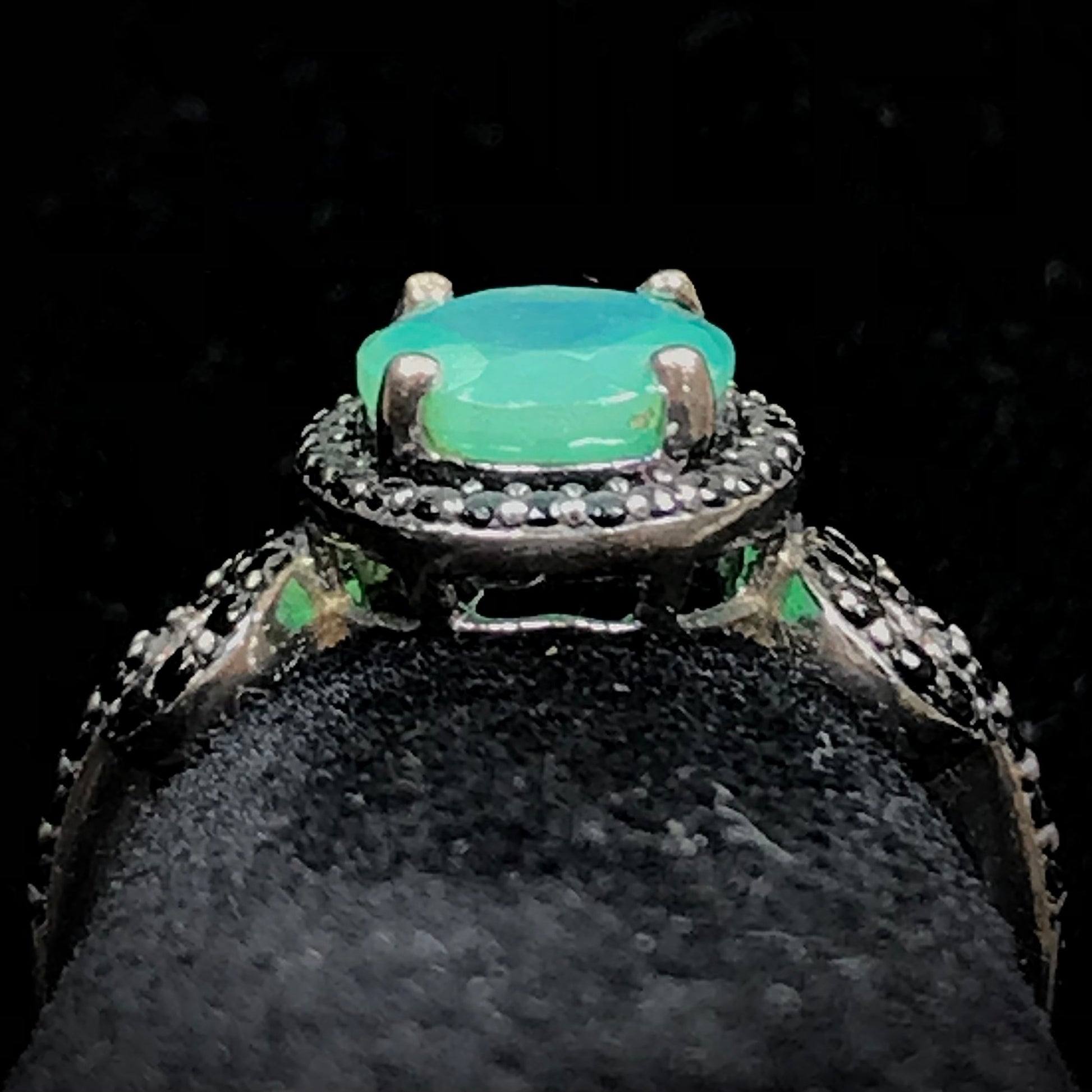 Dyed Ethiopian opal and black spinel prong set into a sterling silver ring.