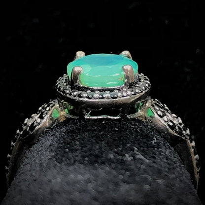 Dyed Ethiopian opal and black spinel prong set into a sterling silver ring.
