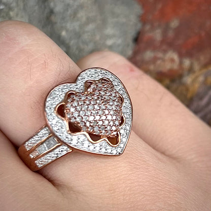 A rose colored metal ring pavé set with round and baguette cut diamonds.