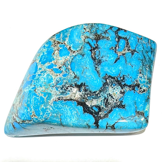 A large polished piece of Kingman turquoise.  The stone is blue with black veining.