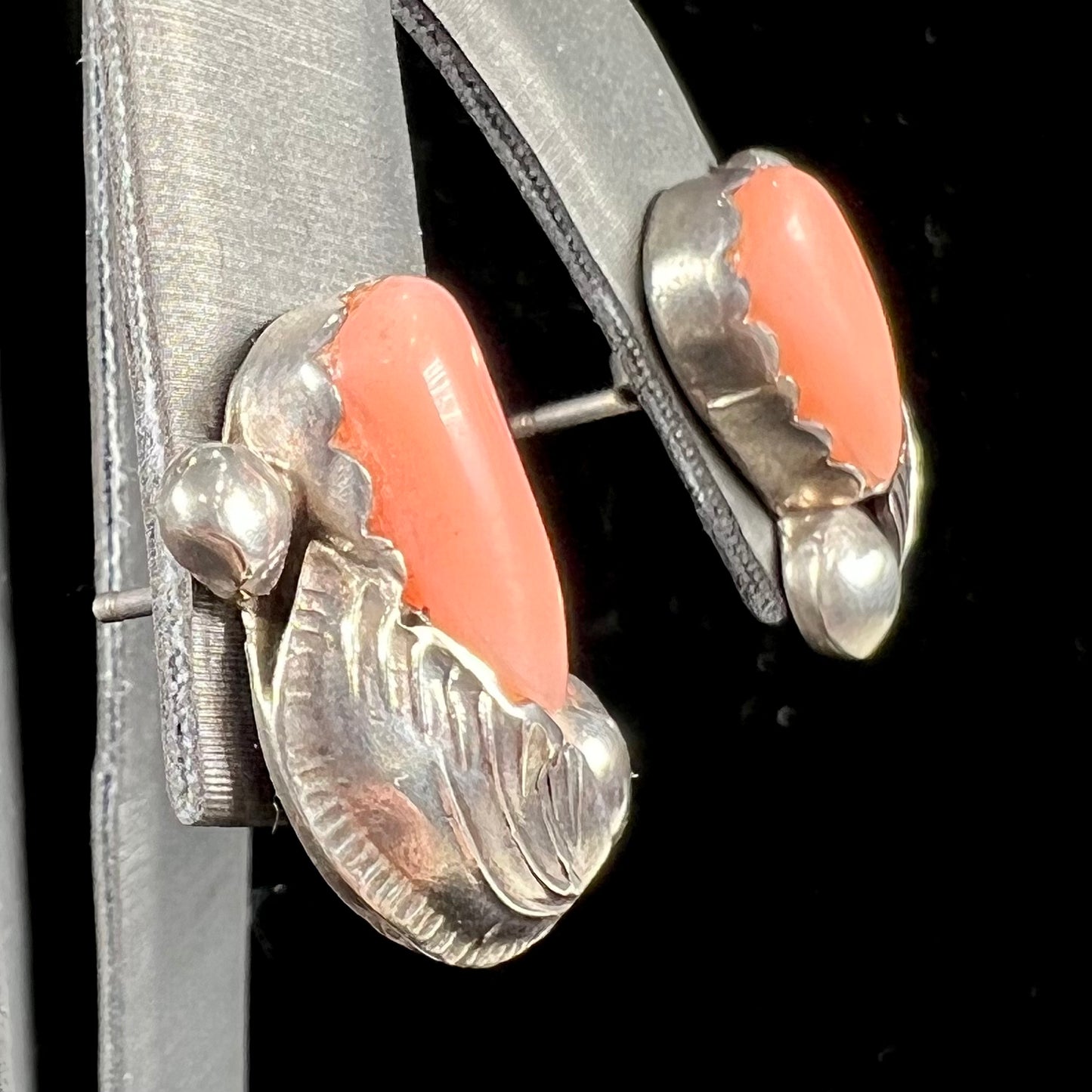 A pair of sterling silver coral earrings handmade by Zuni artists, Carmelita and Dan Simplicio.