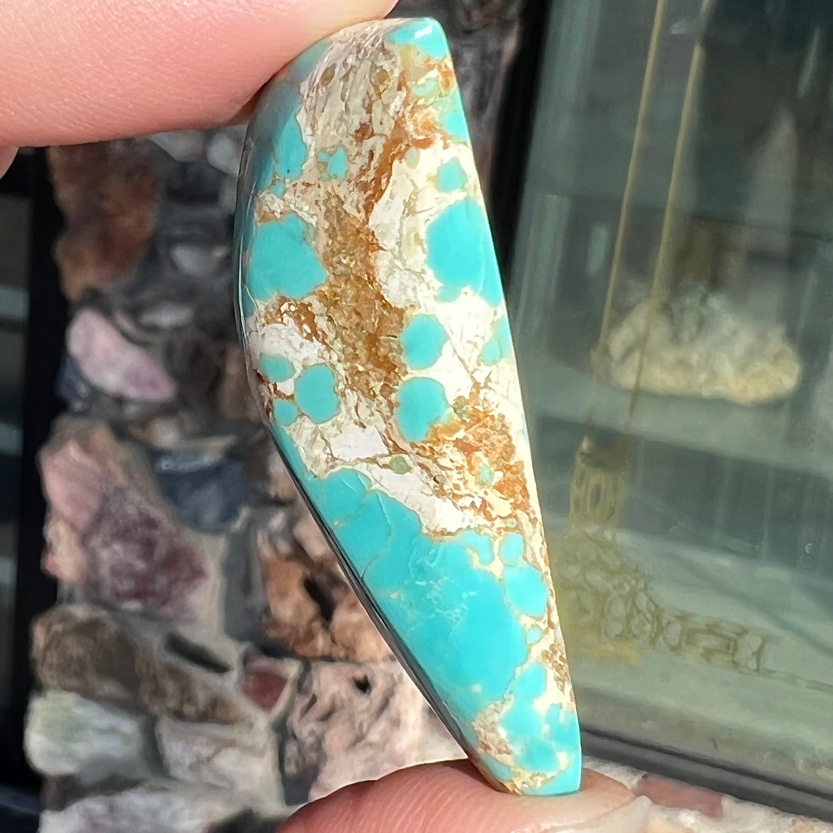 Blue Royston turquoise stone with brown and tan matrix.