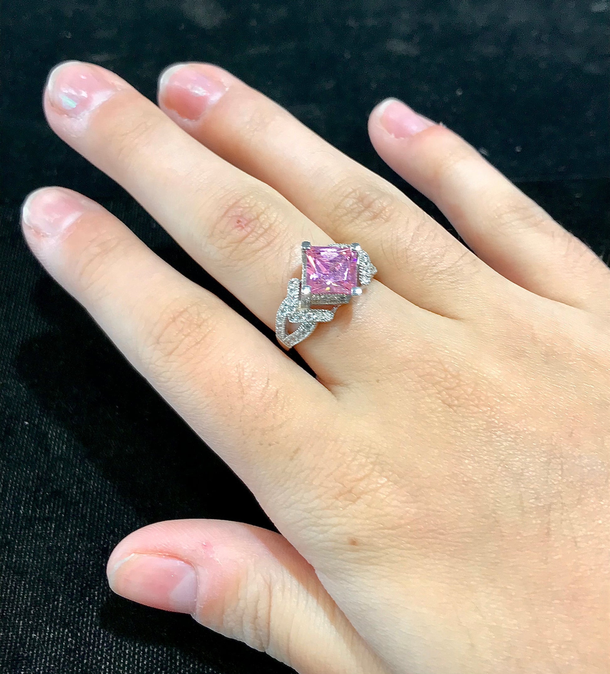 Pink cubic zirconia ring set in sterling silver with white cubic zirconia melee.