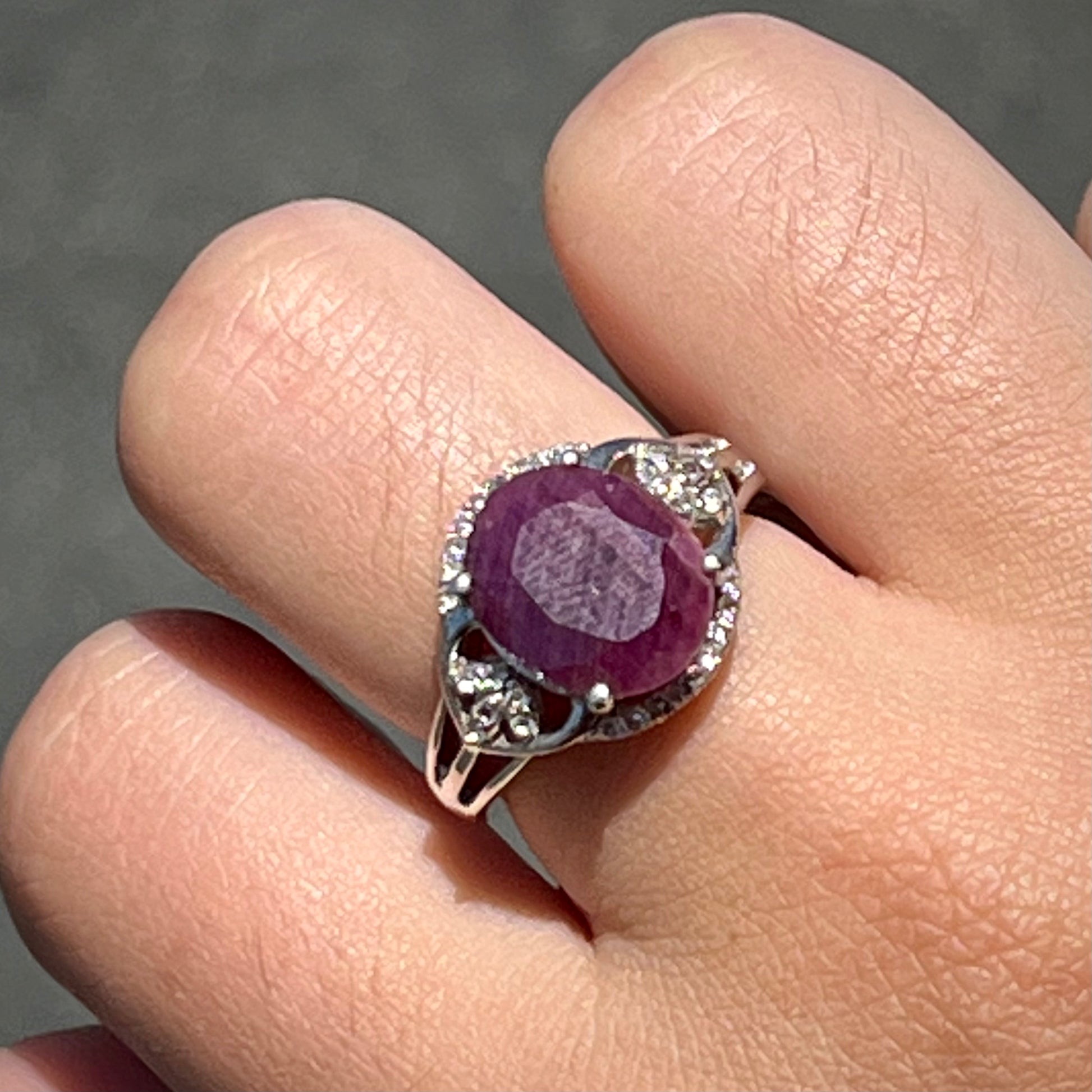 An oval cut natural ruby set in a sterling silver ring.