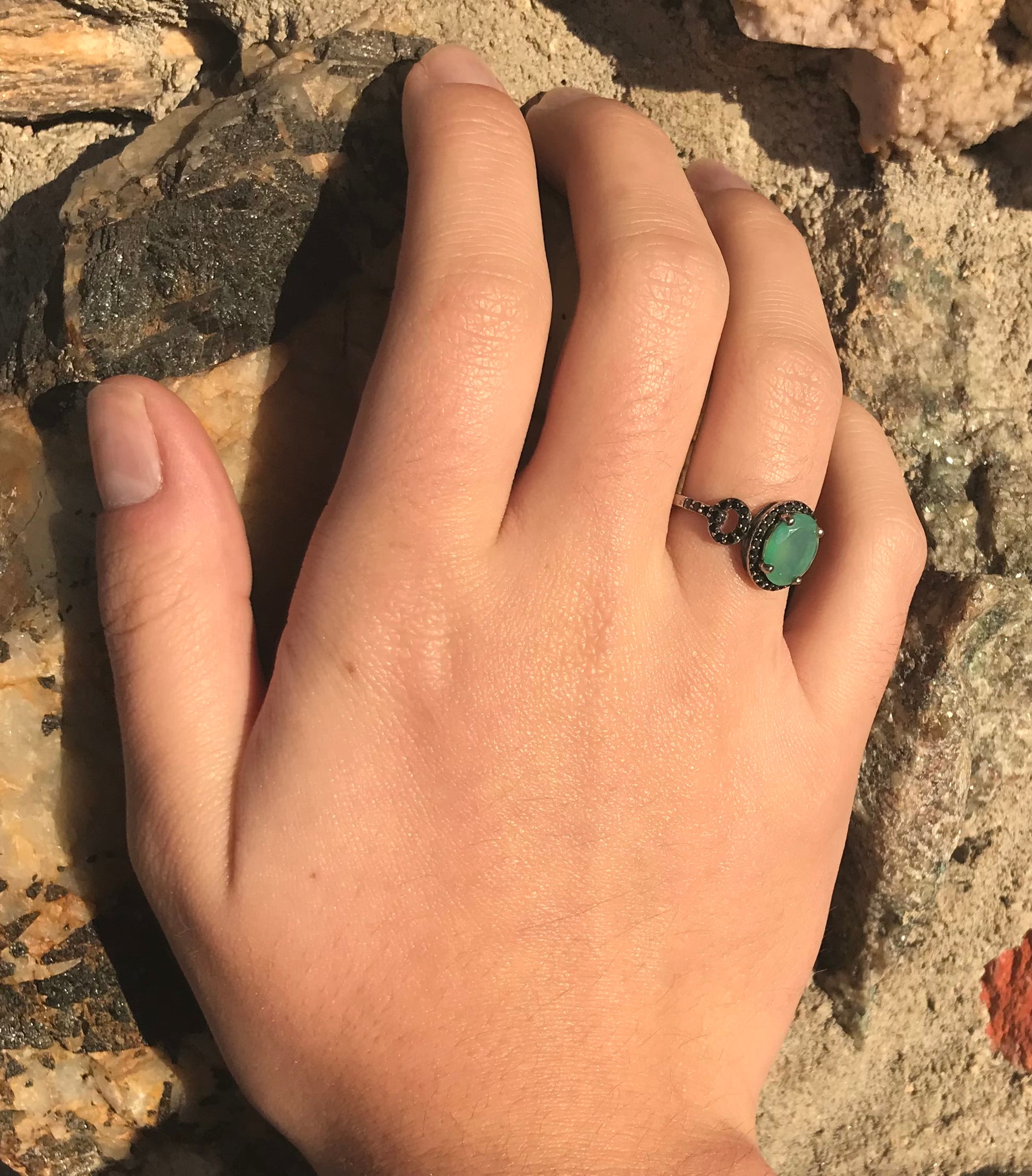 Dyed Ethiopian opal and black spinel prong set into a sterling silver ring.
