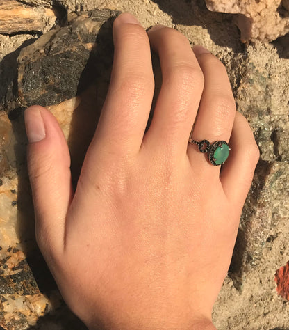 Dyed Ethiopian opal and black spinel prong set into a sterling silver ring.