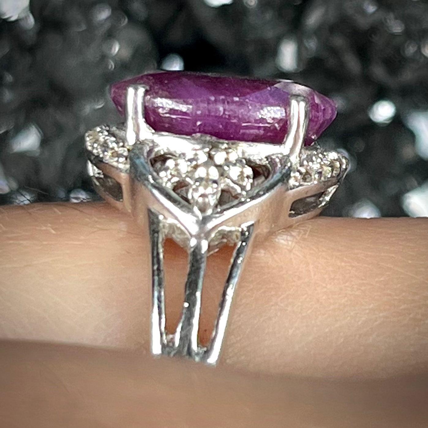 An oval cut natural ruby set in a sterling silver ring.
