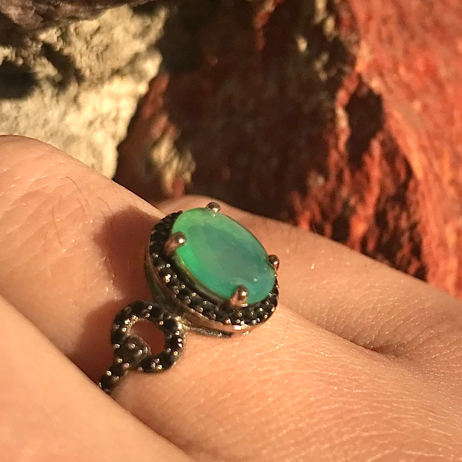 Dyed Ethiopian opal and black spinel prong set into a sterling silver ring.
