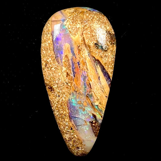 A polished, drilled pipe boulder opal bead.