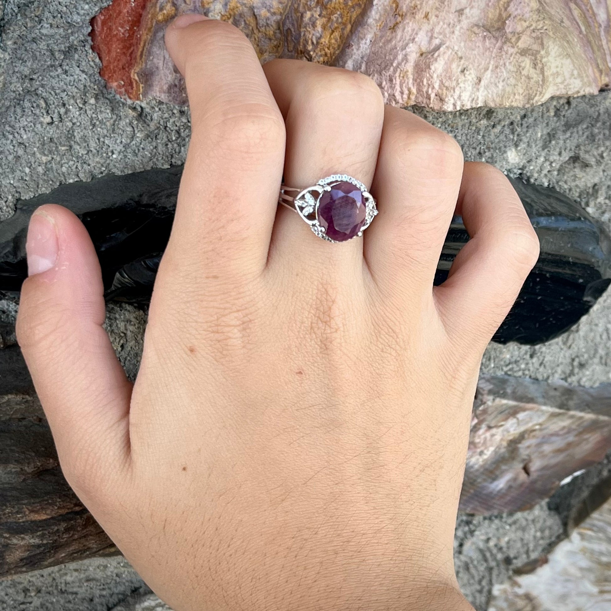 An oval cut natural ruby set in a sterling silver ring.