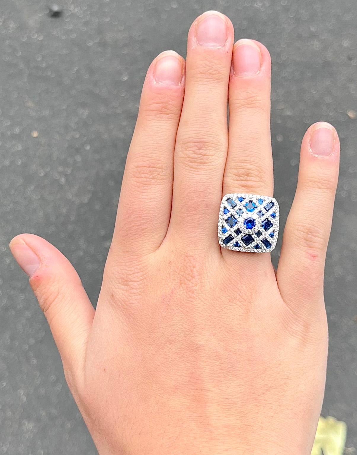 A sterling silver blue and white synthetic stone ring.  The ring strongly resembles a blueberry pie.