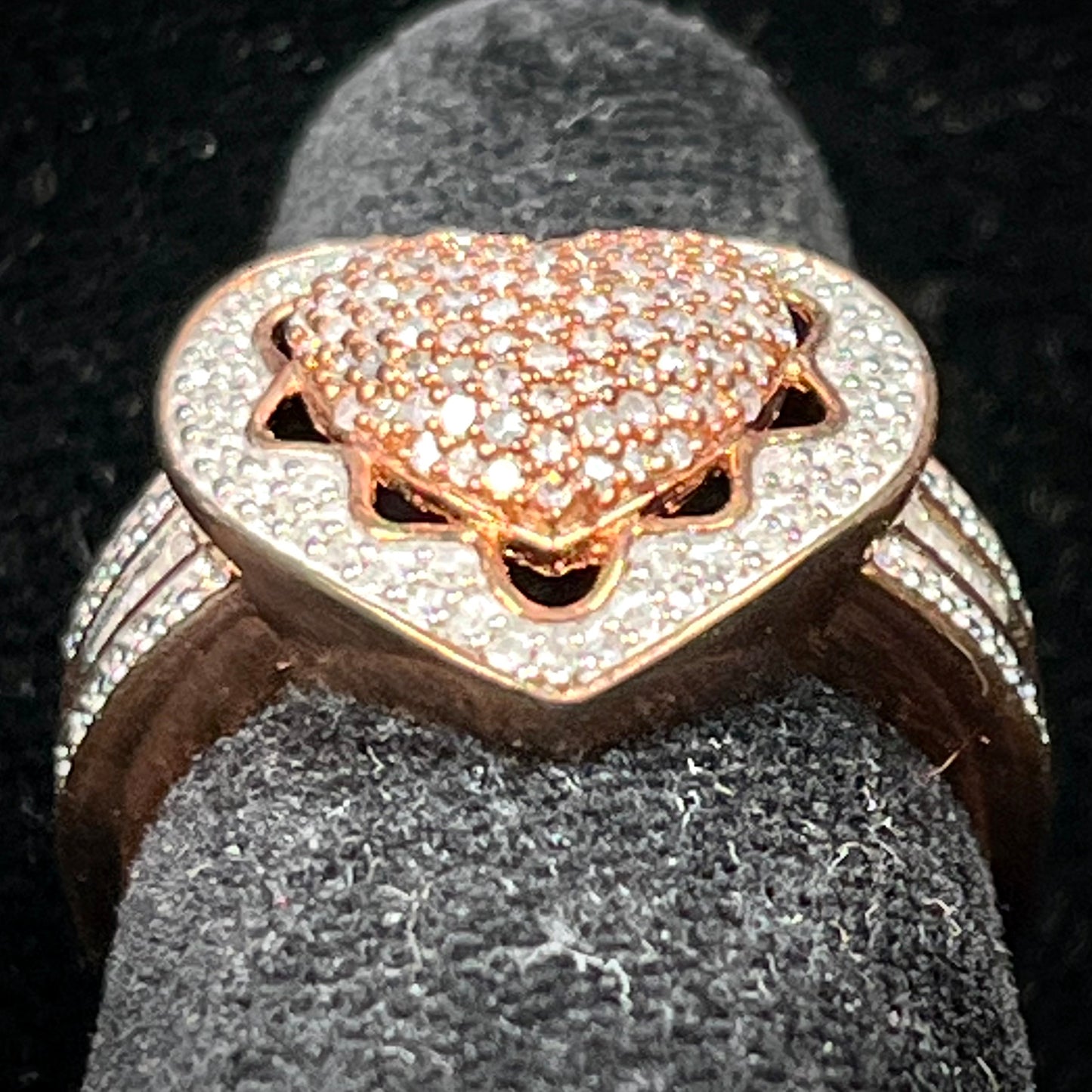 A rose colored metal ring pavé set with round and baguette cut diamonds.