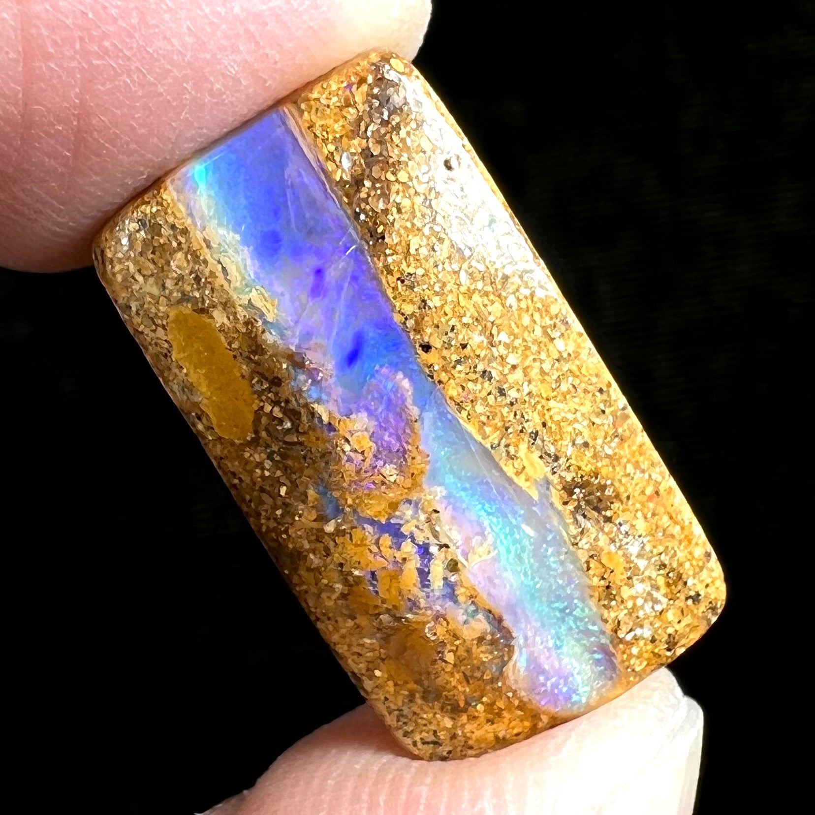 A polished, drilled pipe boulder opal bead.