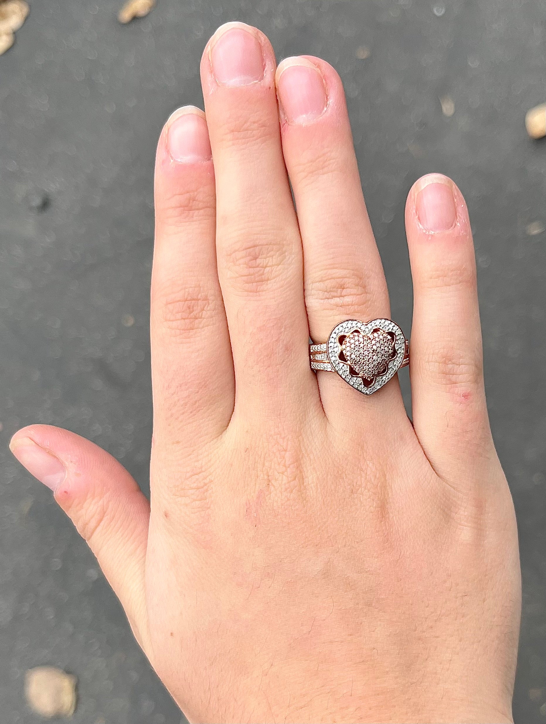 A rose colored metal ring pavé set with round and baguette cut diamonds.
