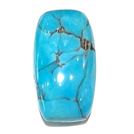 A loose, barrel cabochon cut blue turquoise stone from Burro Mountains, New Mexico.