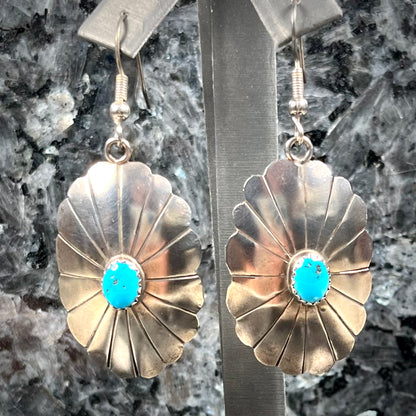 A pair of sterling silver concho turquoise dangle earrings.