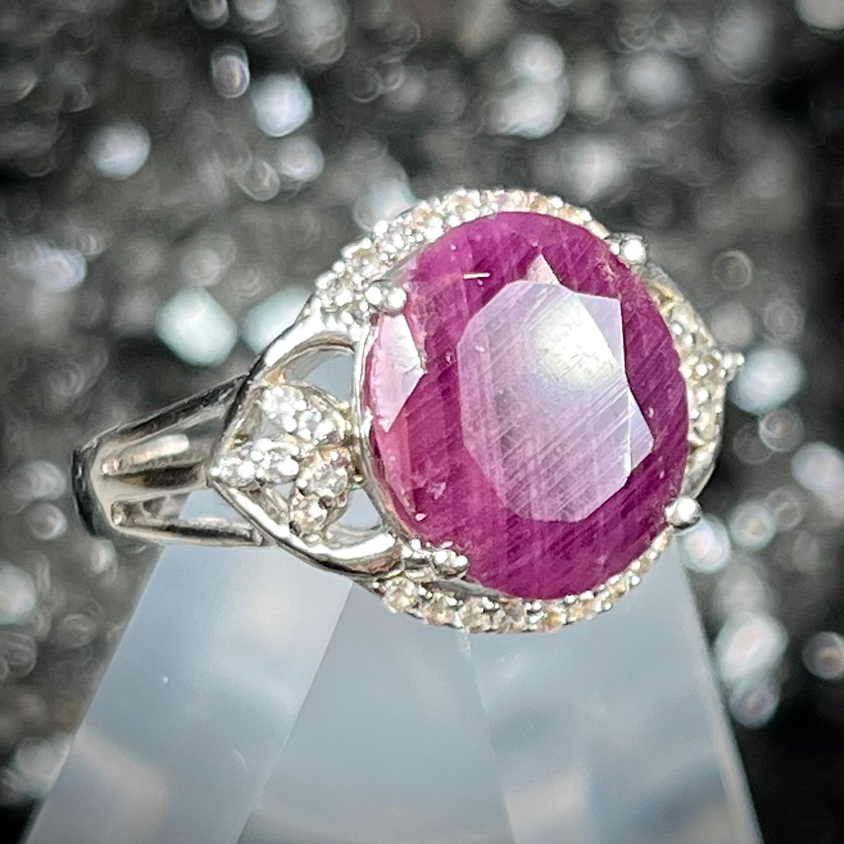 An oval cut natural ruby set in a sterling silver ring.