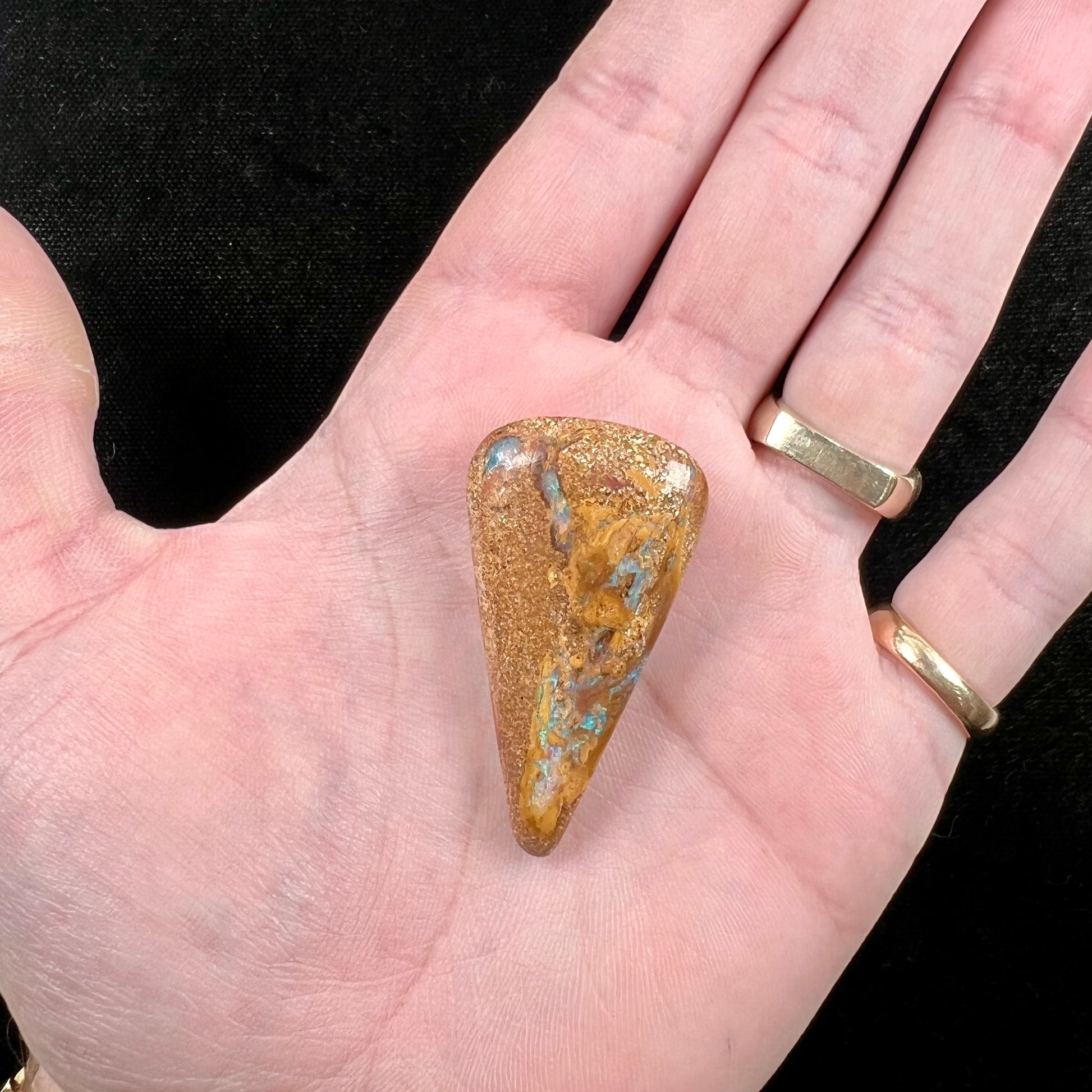 A polished, drilled pipe boulder opal bead.
