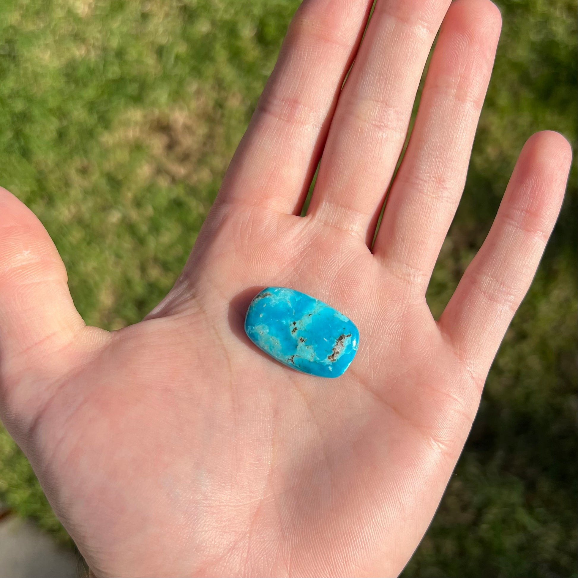 A blue barrel cabochon cut turquoise stone from the Sleeping Beauty Mine.