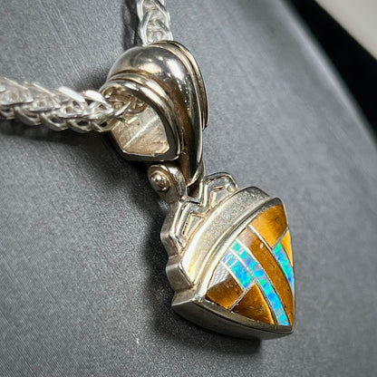 Tigers Eye and synthetic opal triangle inlay pendant set in sterling silver.