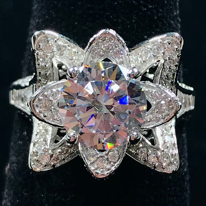 A blooming flower motif ring set with round, white cubic zirconia.