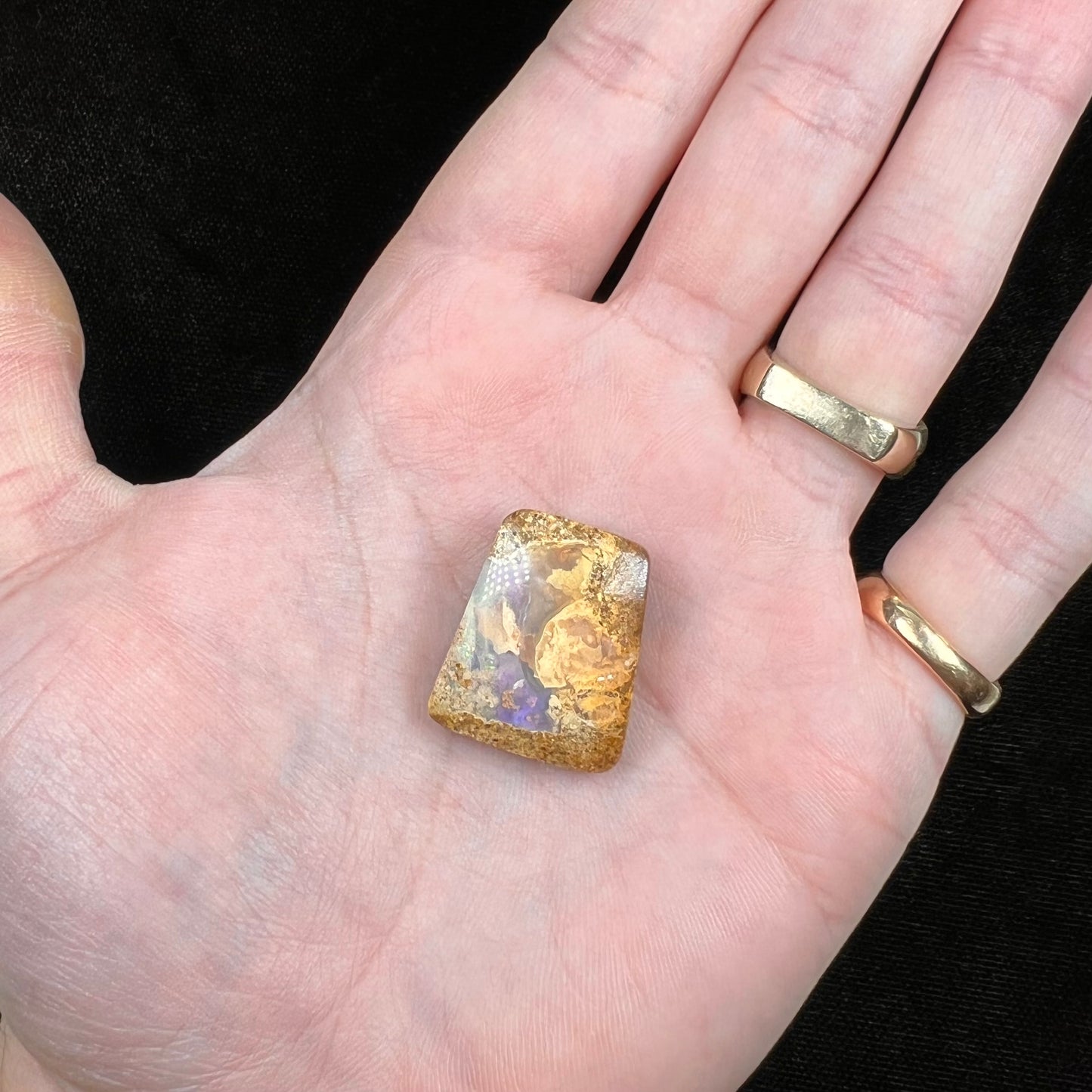 A polished, drilled pipe boulder opal bead.