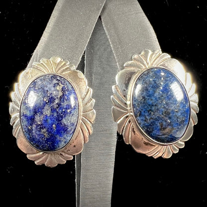 A pair of sterling silver lapis lazuli earrings handmade by Navajo artist, Filbert Brown.