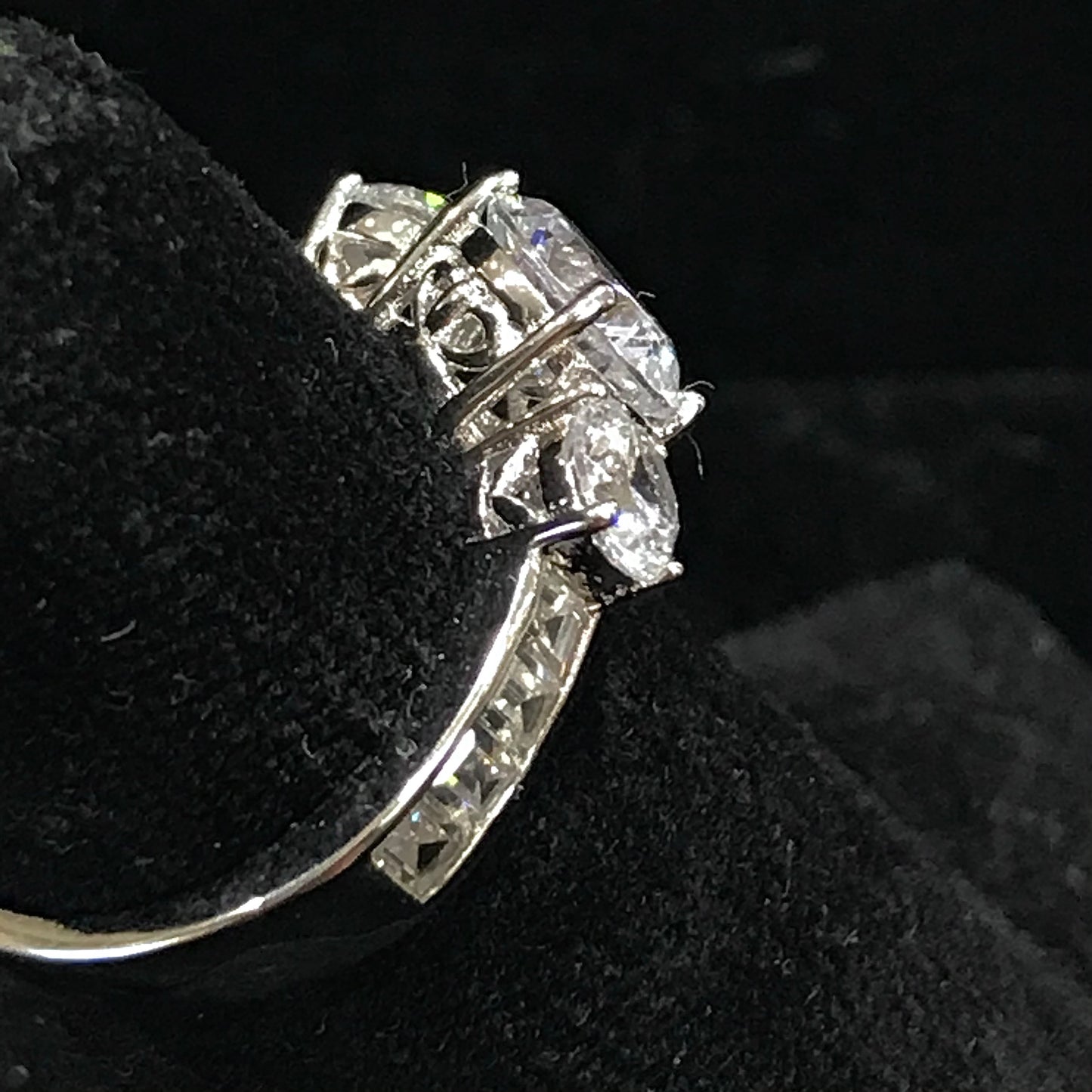 A sterling silver ring set with three round cut cubic zirconia stones.