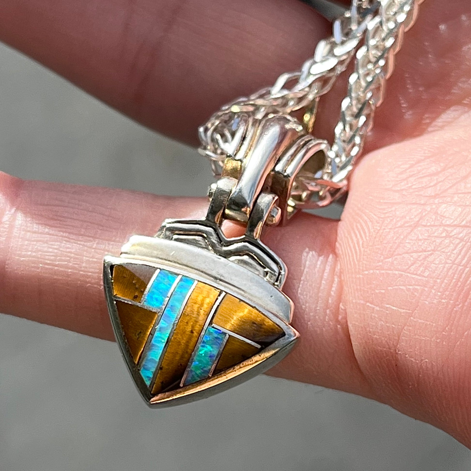 Tigers Eye and synthetic opal triangle inlay pendant set in sterling silver.