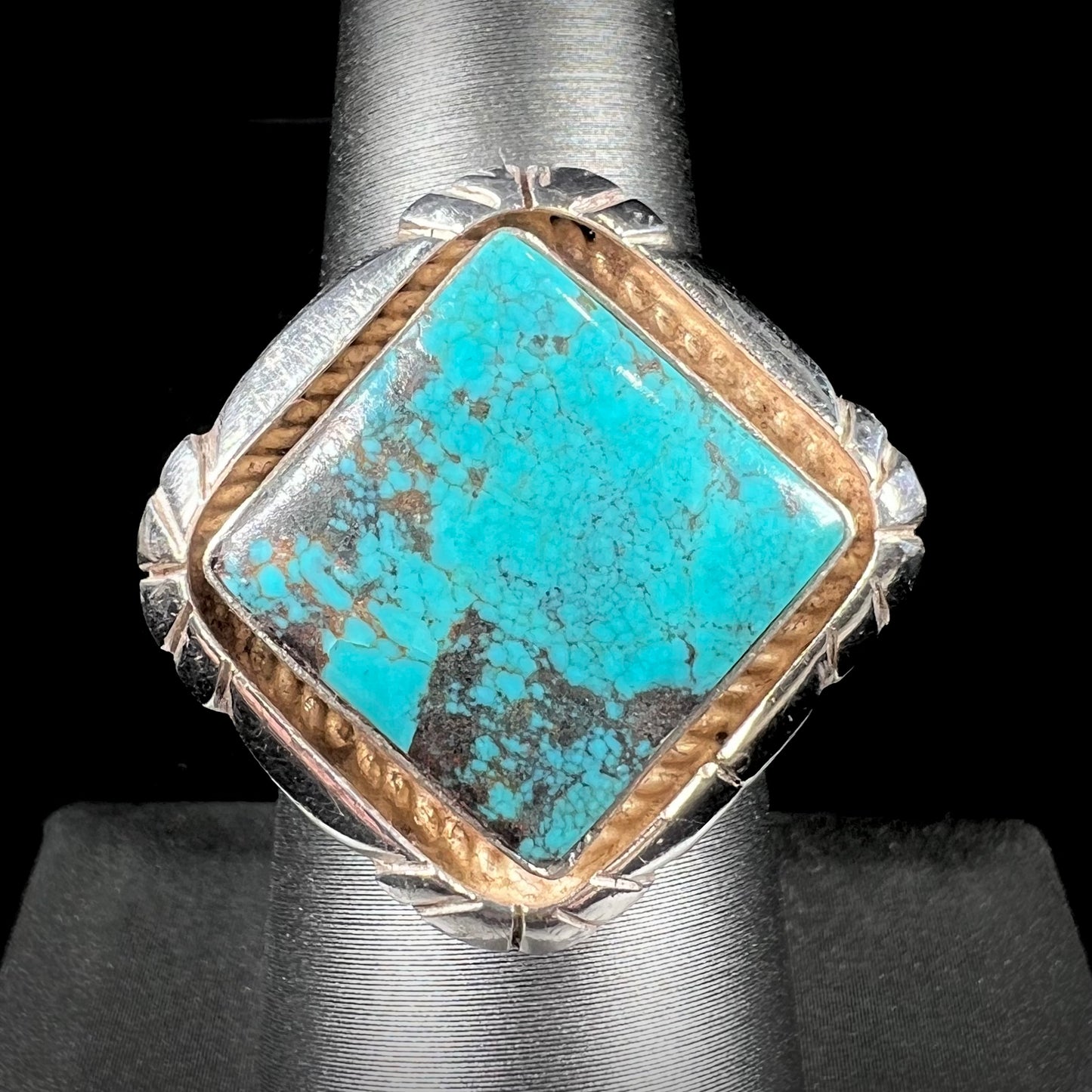 A handmade sterling silver, unisex, likely Navajo ring set with Tibetan turquoise.