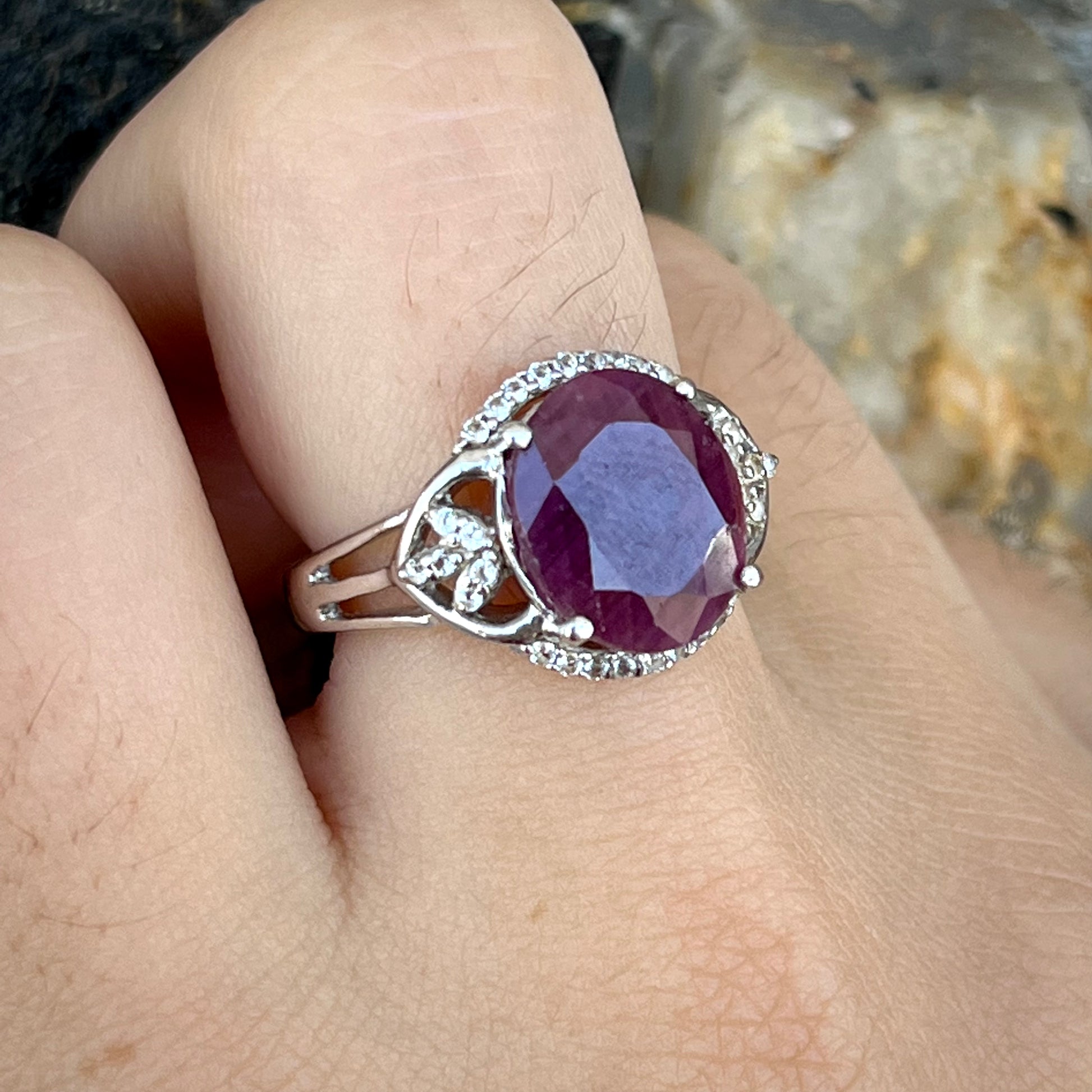 An oval cut natural ruby set in a sterling silver ring.