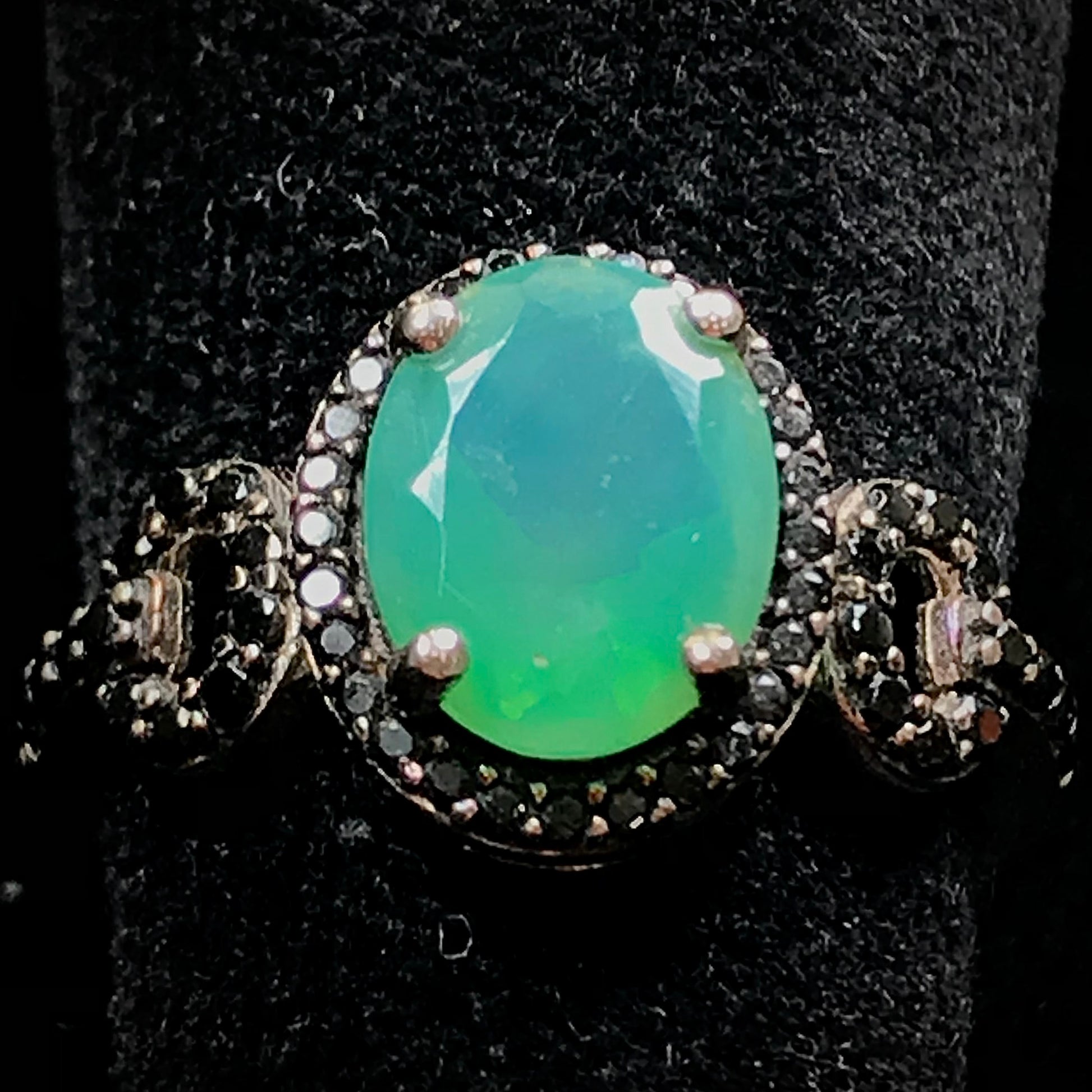Dyed Ethiopian opal and black spinel prong set into a sterling silver ring.