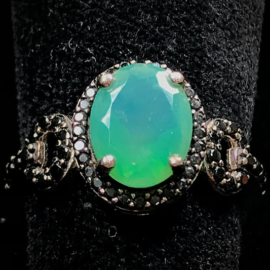 Dyed Ethiopian opal and black spinel prong set into a sterling silver ring.
