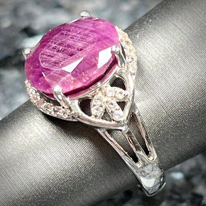 An oval cut natural ruby set in a sterling silver ring.