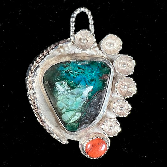 A sterling silver Navajo-style pendant set with chrysocolla and red jasper stones.