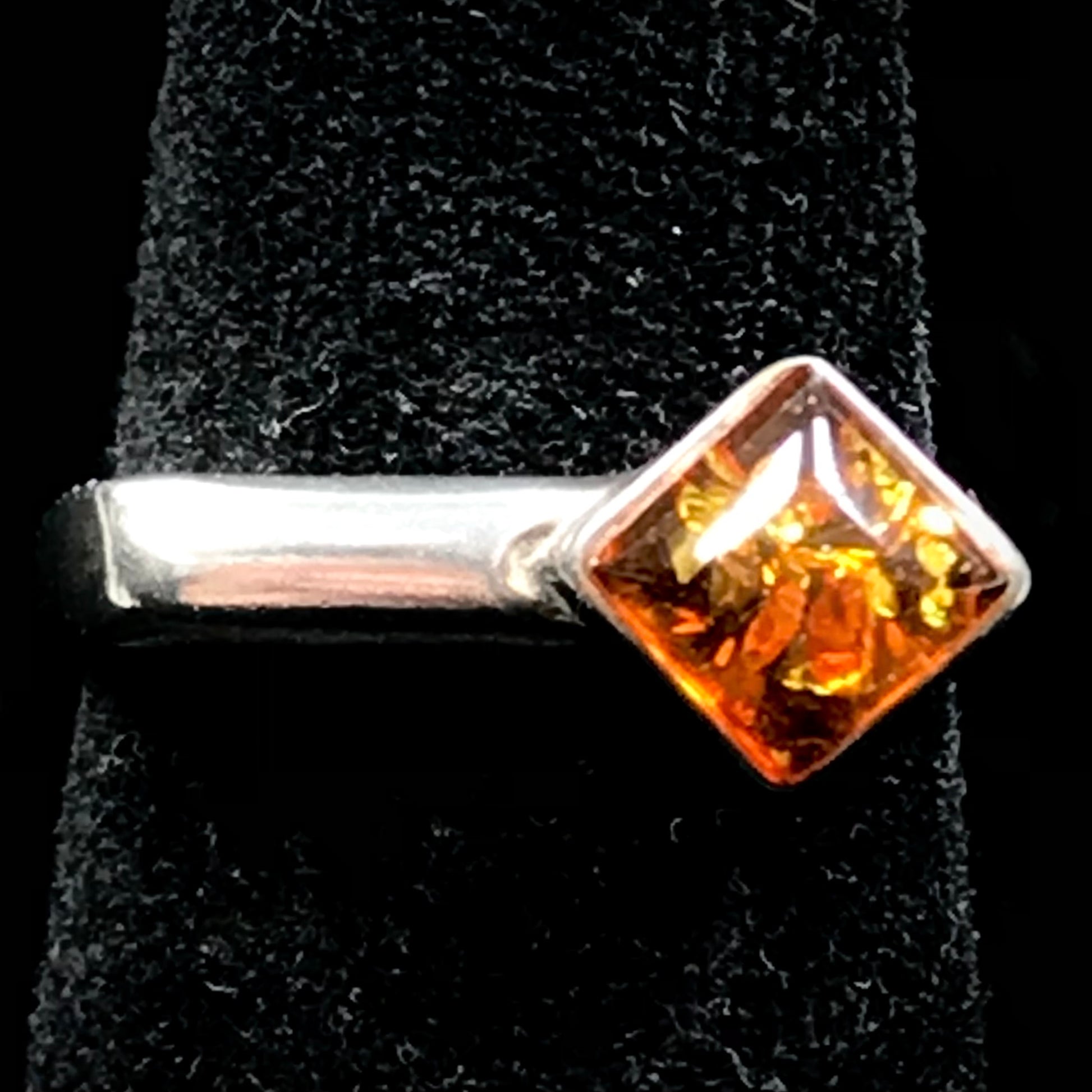 Square shaped Baltic Amber cabochon set in a unique sterling silver ring.