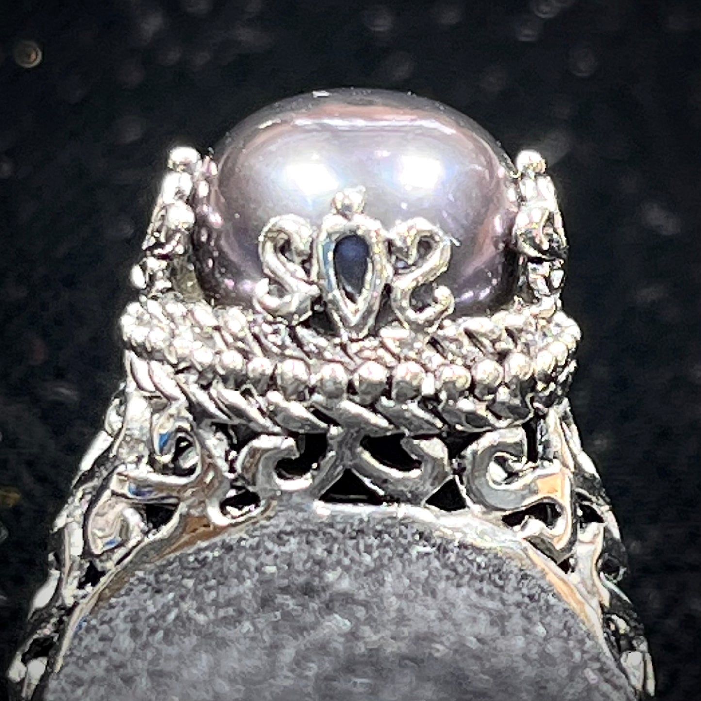 A vintage style sterling silver black pearl filigree ring.