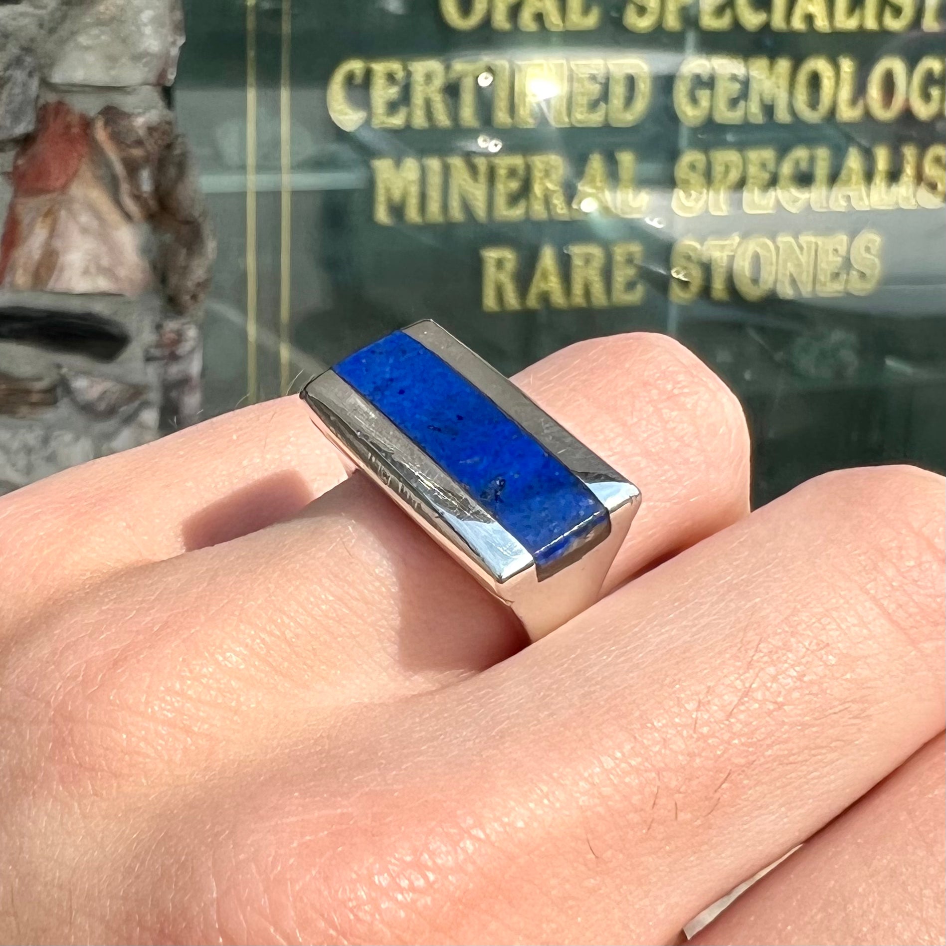 A sterling silver ring inlaid with a piece of lapis lazuli.  A small crack runs through the piece of lapis.